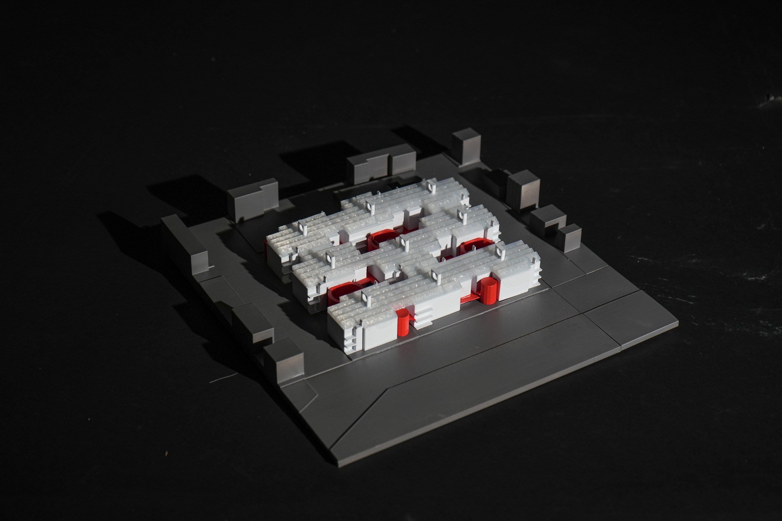 Black study model with red cores defining a central courtyard