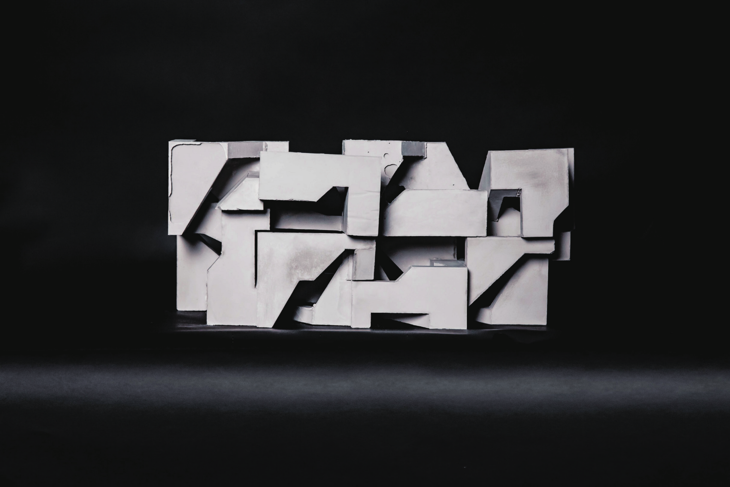 Concrete casting studies arranged on a black background