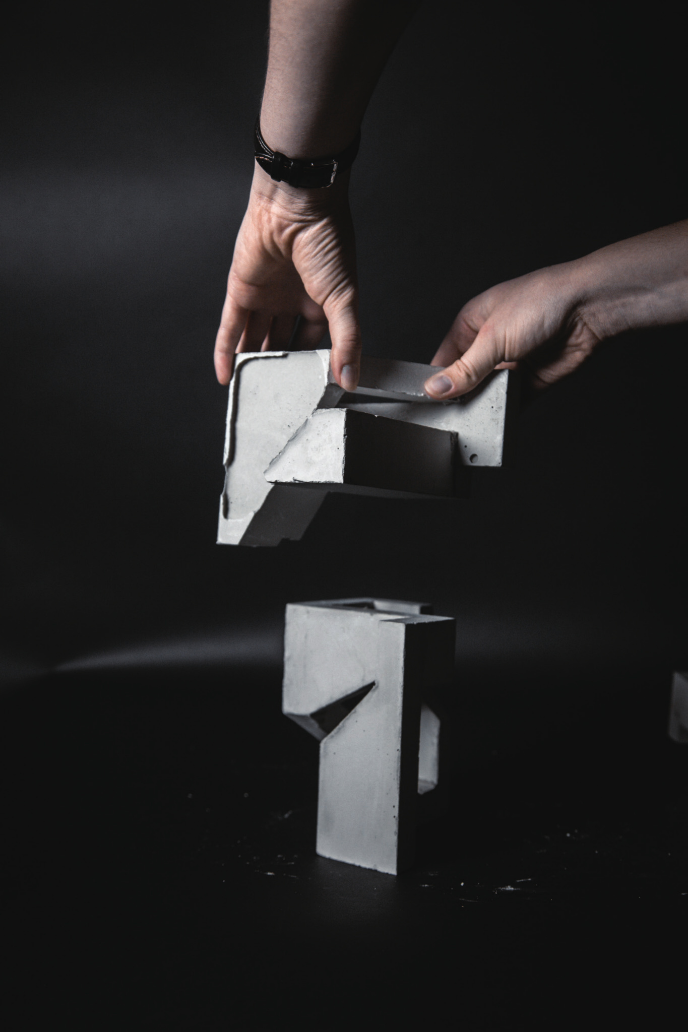 Two concrete studies being joined by hand